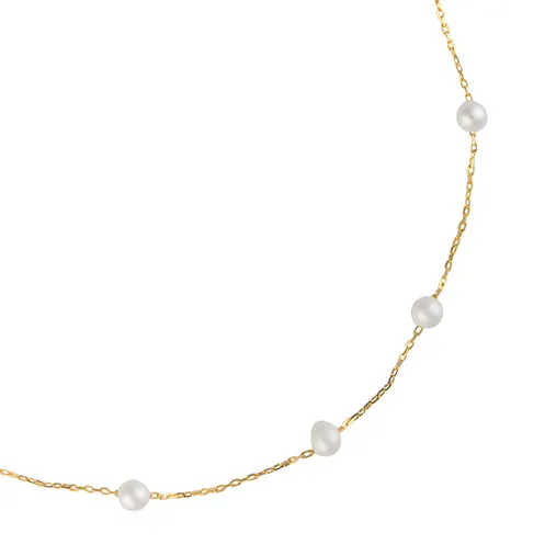 Tin cup with small freshwater pearl necklace in gold